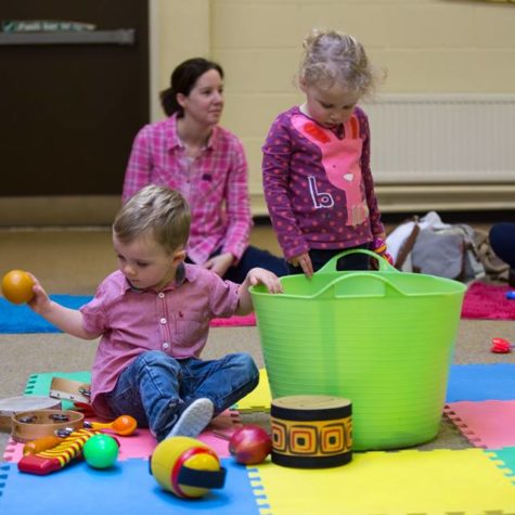 Image shows parents and toddlers enjoying Music Bugs class