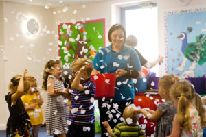 Image shows toddlers enjoying sensory time in Music bugs class with Class Leader